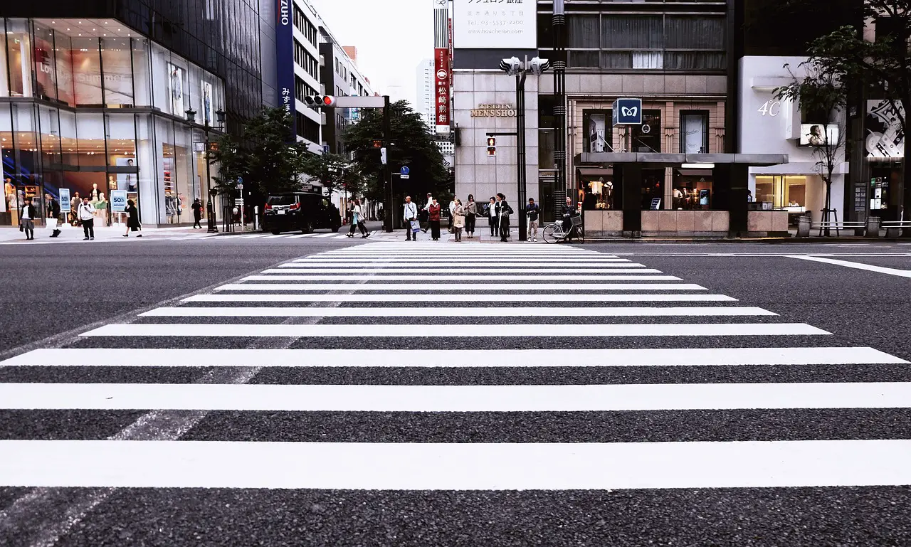 buildings pedestrian crossing city crossing pedestrians people road street city street city road road road street street street street street city street