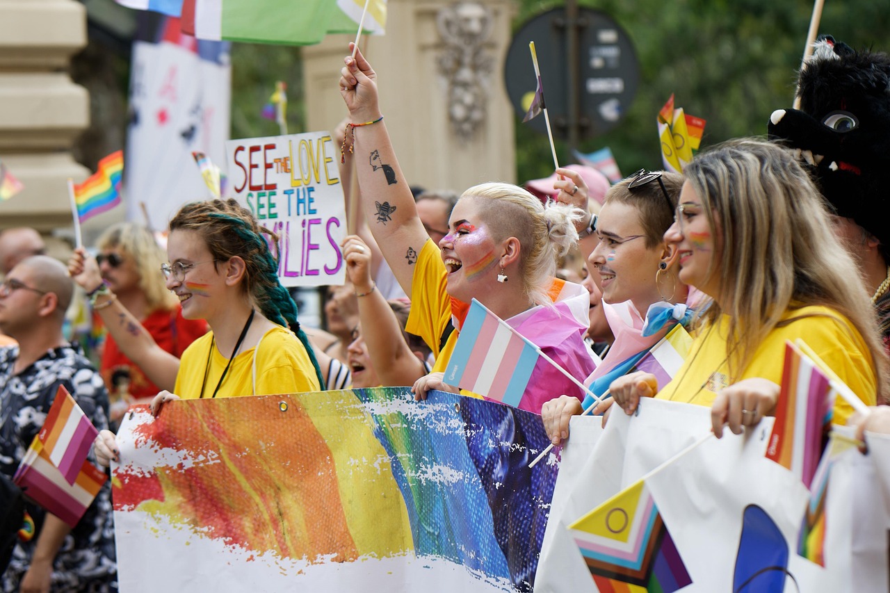 people ladies girls colors flags advocacy event pride parade mark the street urban town community cheerfulness exuberance physiognomy claim rights