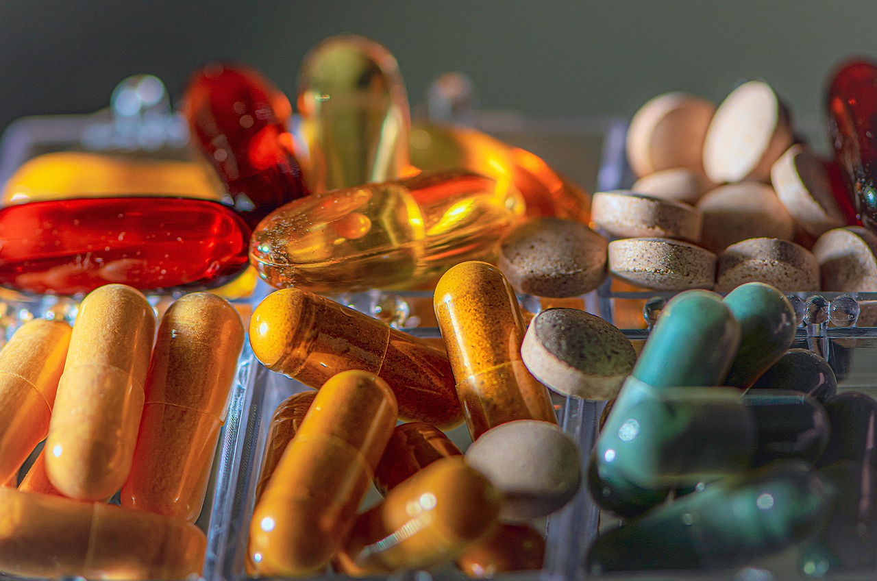 vitamins pills pharmacy medication macro in a box colorful meds supplements pharma microelements health benefit from aid capsules medical omega 3 fish oil mood raising medicine pill in store healthcare capsule pharmaceutical